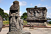 Candi Panataran - Main Temple. Giant guardians to left of the staircase of the temple with  the Naga temple.  